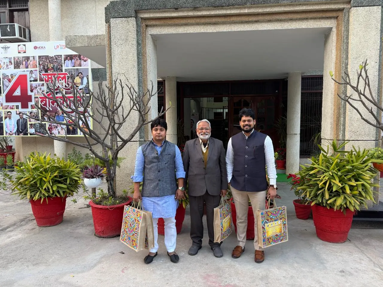 Dr. Harish Pandey standing with two fellow academics outside a building