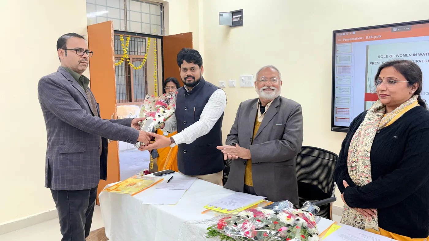 Dr. Harish Pandey being welcomed with a bouquet at an academic session
